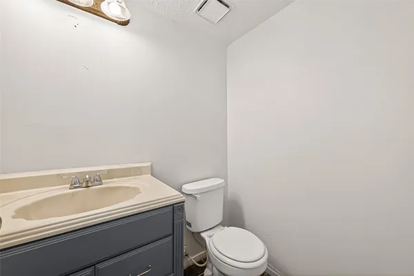 an empty room with windows fireplace and wooden floor