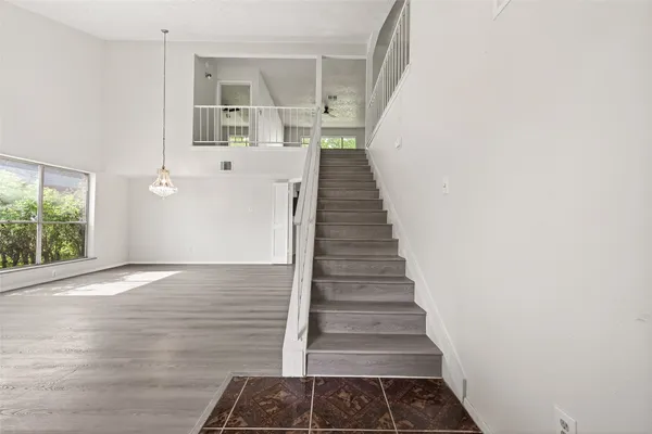 a view of entryway and hall with wooden floor