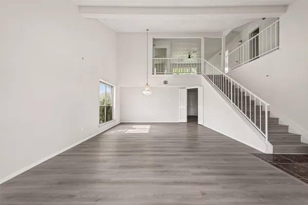 wooden floor in an empty room with a window and wooden floor