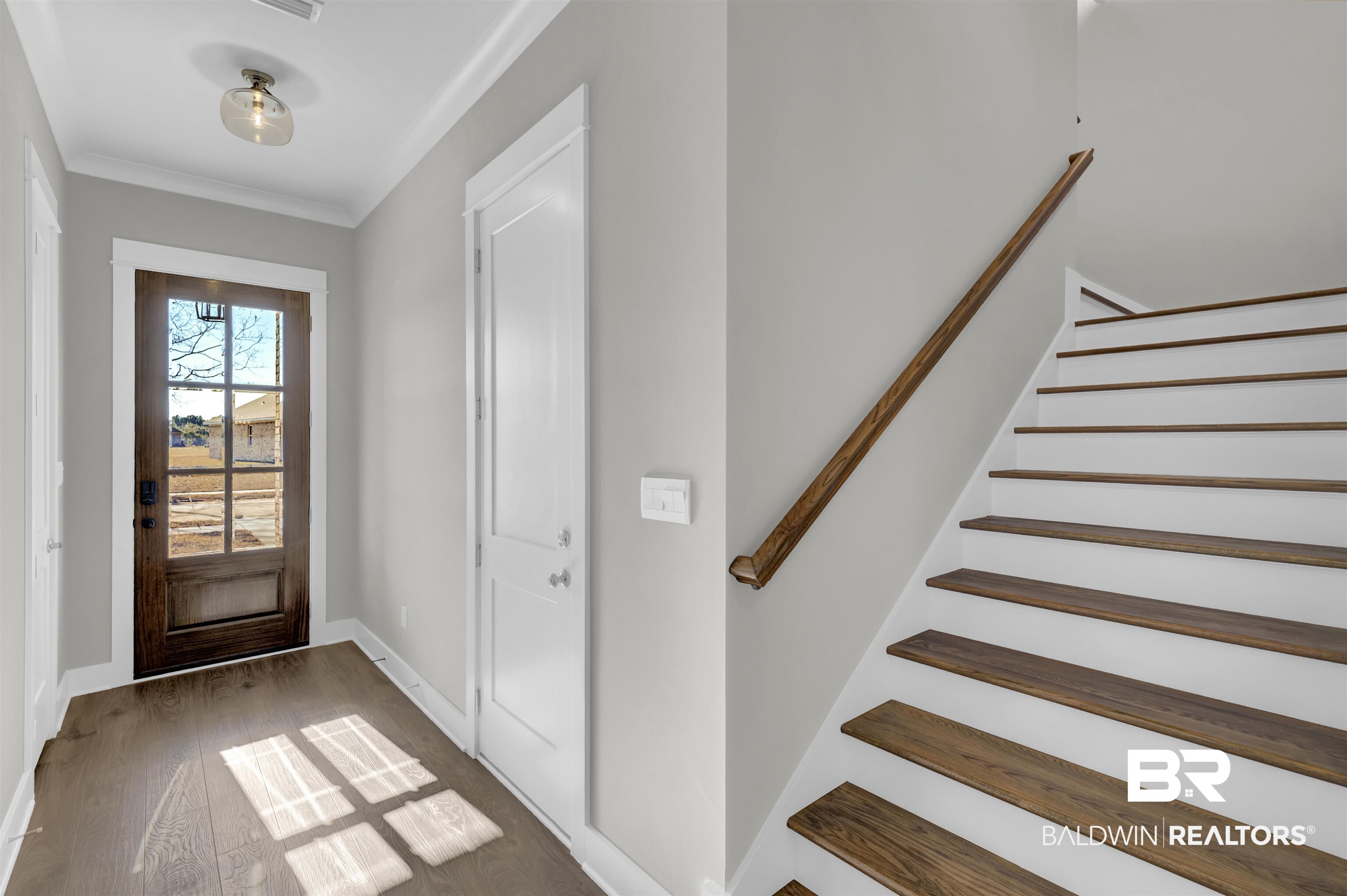 571 Morning Mist Way Fairhope, AL 36532 - Photo 2 of 47 Foyer featuring hardwood / wood-style floors, crown molding, and stairway