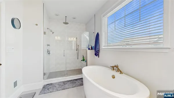 a bathroom with a bathtub and shower