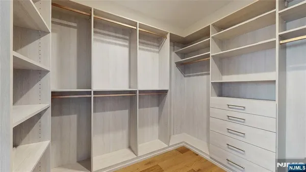 a view of walk in closet with empty racks