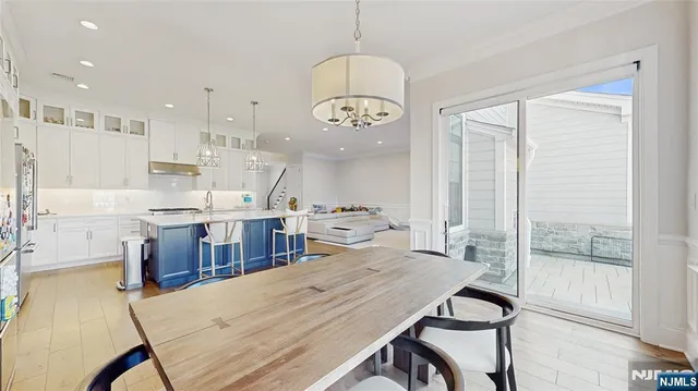 a large kitchen with a table and chairs