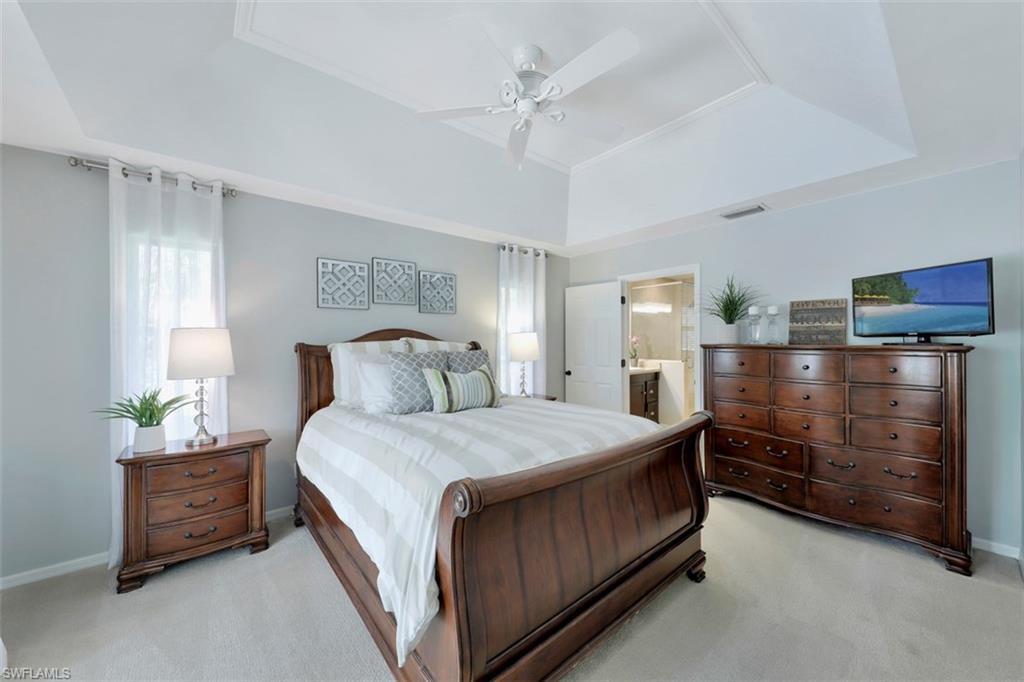 5260 Mahogany Ridge Drive Naples, FL 34119 - Photo 11 of 15 a bedroom with a bed and a dresser