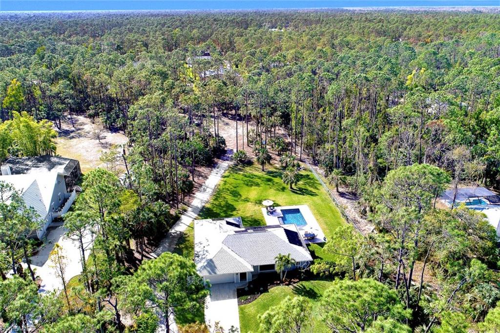 5260 Mahogany Ridge Drive Naples, FL 34119 - Photo 15 of 15 an aerial view of house with yard swimming pool and outdoor seating