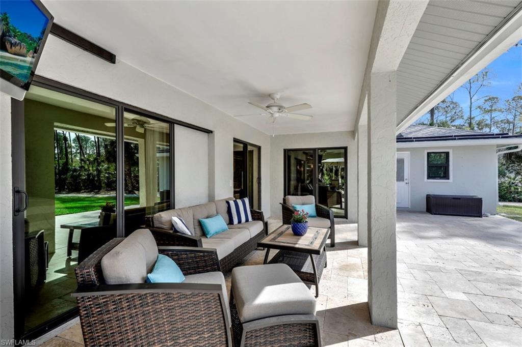 5260 Mahogany Ridge Drive Naples, FL 34119 - Photo 4 of 15 a outdoor space with patio the couches and a dining table with garden view
