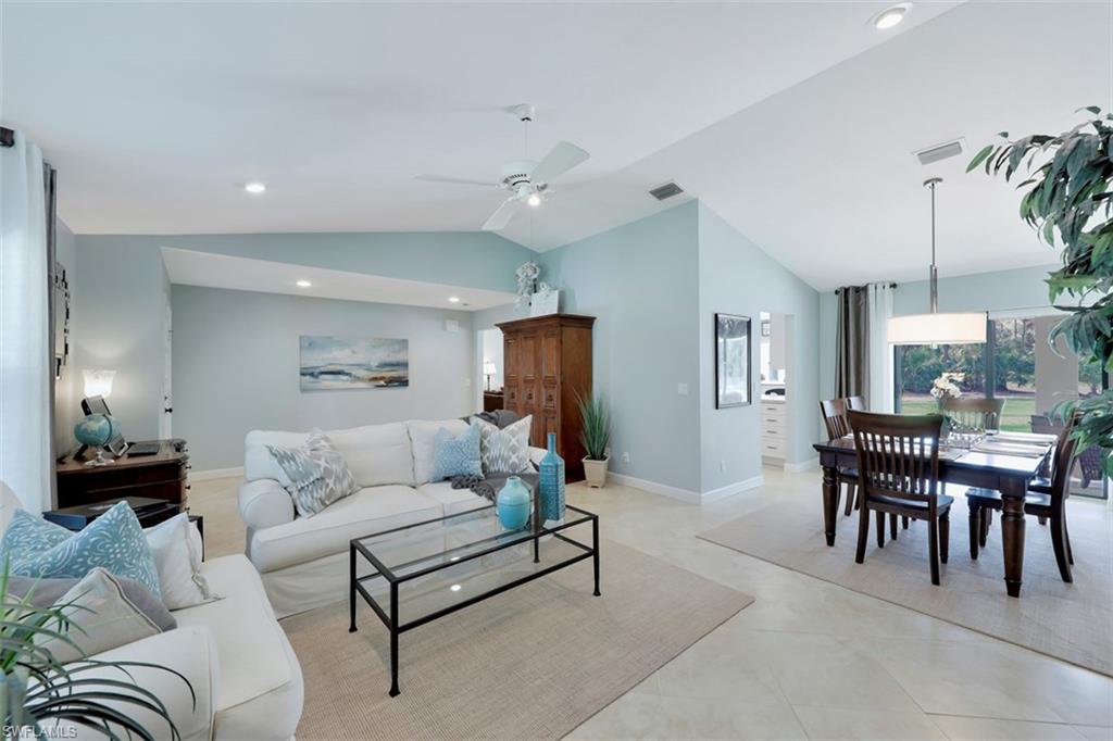 5260 Mahogany Ridge Drive Naples, FL 34119 - Photo 5 of 15 a living room with furniture a table and a potted plant