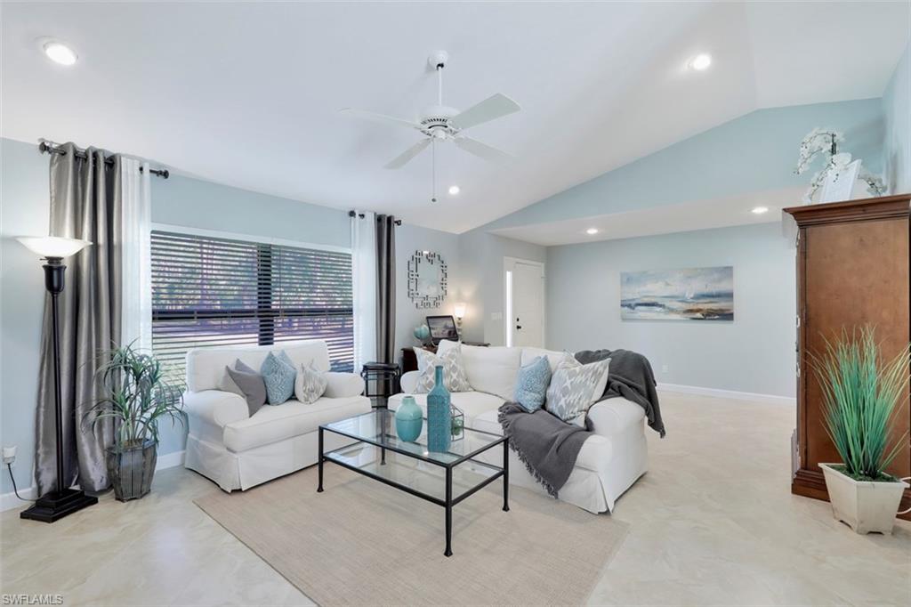 5260 Mahogany Ridge Drive Naples, FL 34119 - Photo 6 of 15 a living room with furniture potted plant and a large window