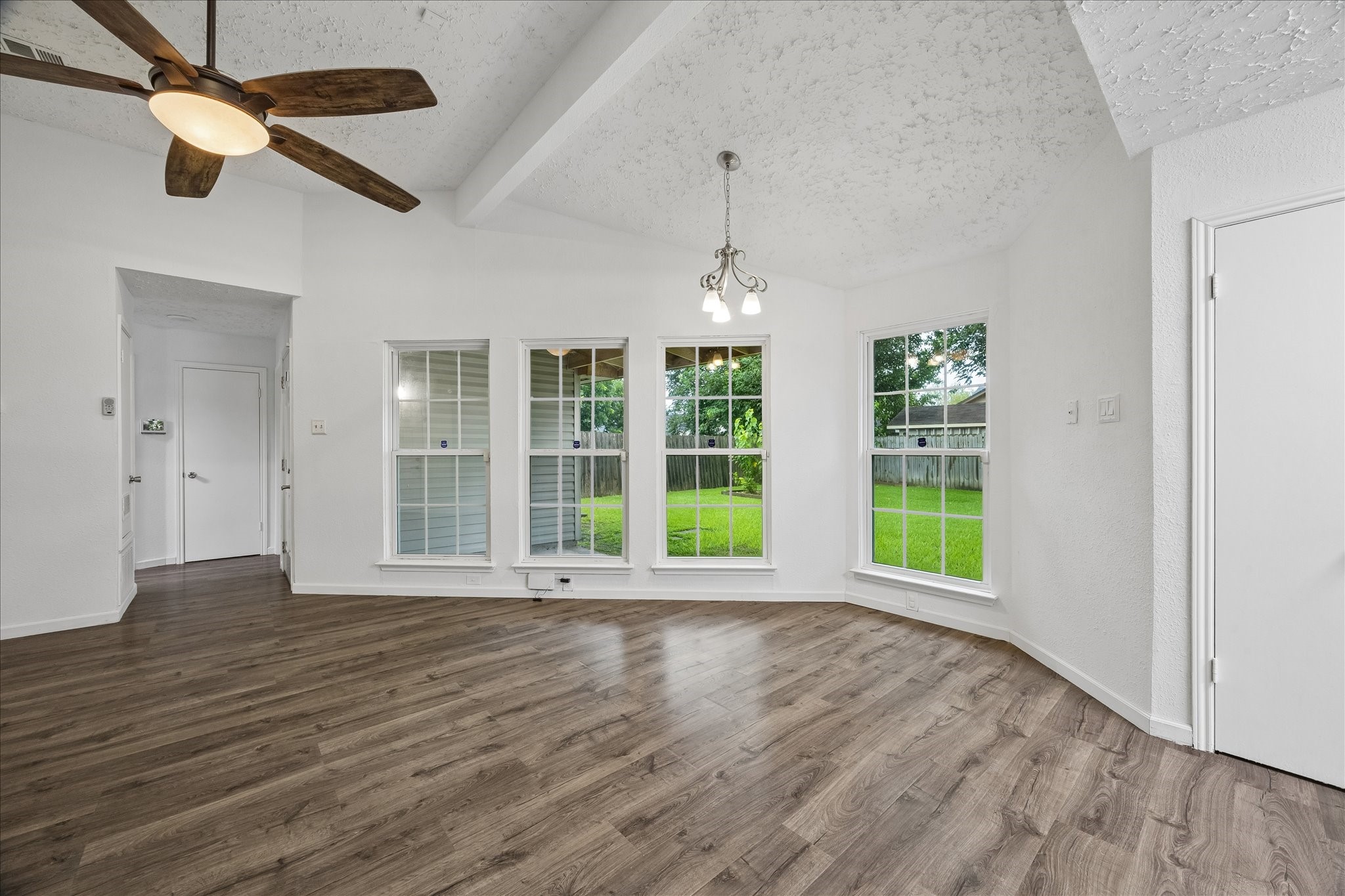 16715 Benchmark Drive Houston, TX 77053 - Photo 3 of 14 an empty room with wooden floor and windows