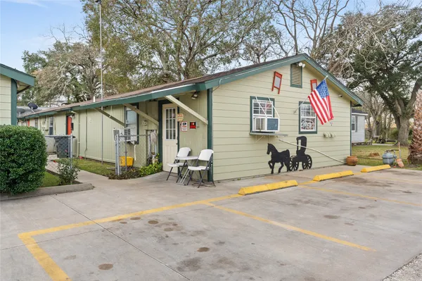 a view of a house with backyard and sitting area