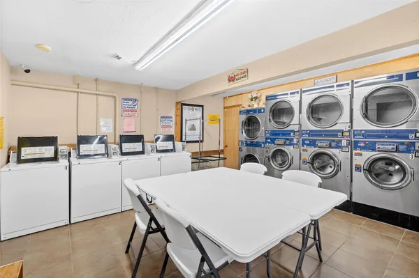 a view of a dining room with furniture and a window
