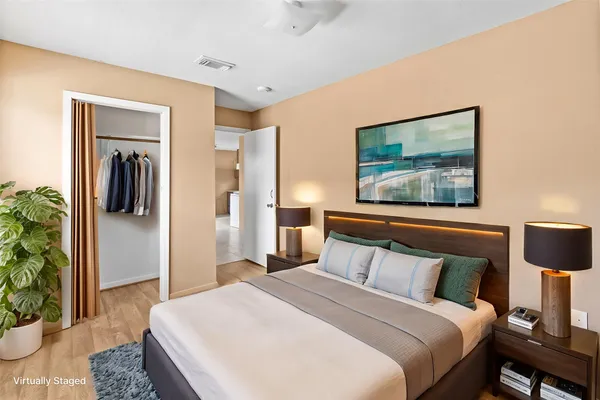 a bedroom with a bed and a painting on the wall