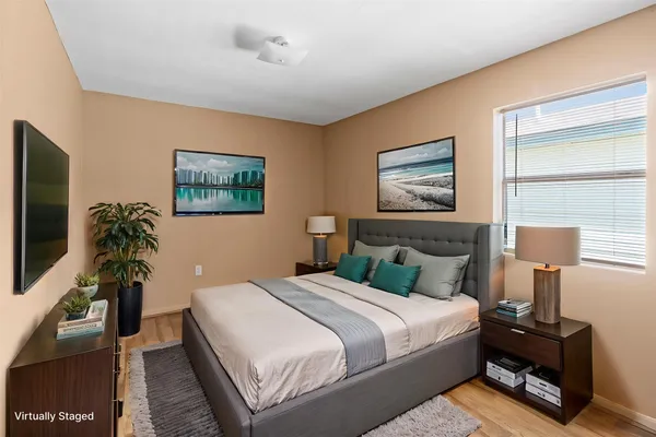 a bedroom with furniture and a flat screen tv