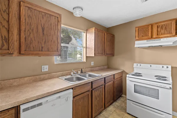 a utility room with sink dryer and washer