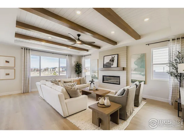 a living room with fireplace furniture and a floor to ceiling window