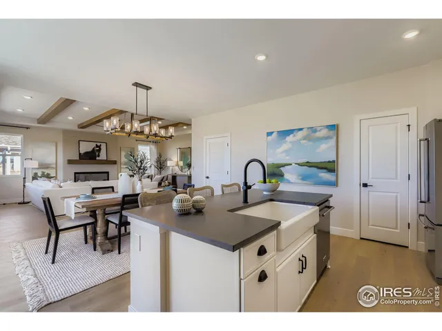 a kitchen with stainless steel appliances granite countertop a sink a stove and a refrigerator