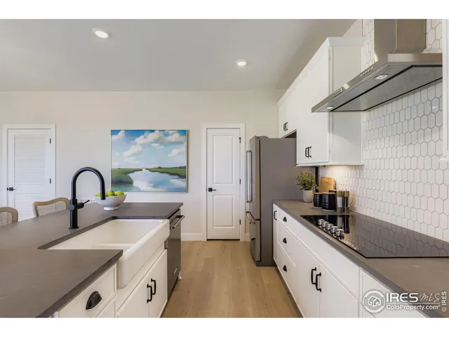 a kitchen with stainless steel appliances a sink a stove and refrigerator