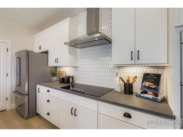 a kitchen with stainless steel appliances granite countertop a sink a stove and refrigerator