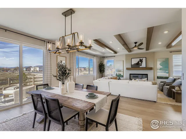 a dining room with furniture window and wooden floor