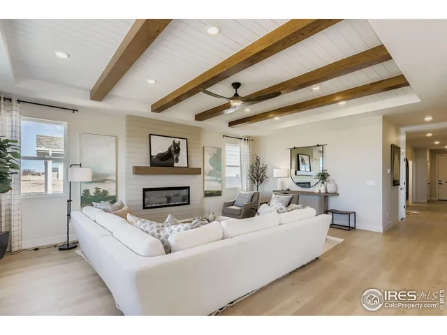 a living room with fireplace furniture and a wooden floor