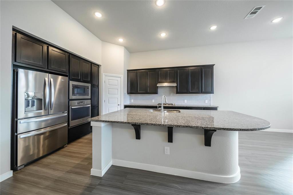 1113 Sheldon Drive Anna, TX 75409 - Photo 15 of 35 a kitchen with stainless steel appliances a sink and a refrigerator
