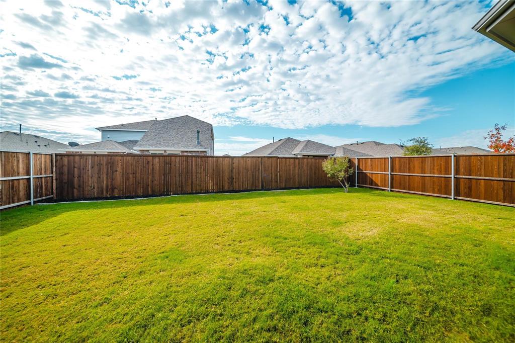1113 Sheldon Drive Anna, TX 75409 - Photo 32 of 35 a view of a yard with wooden fence