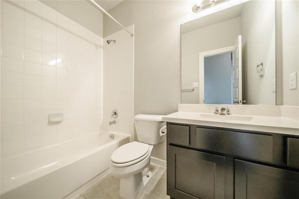 1113 Sheldon Drive Anna, TX 75409 - Photo 10 of 35 a bathroom with a sink a toilet and shower