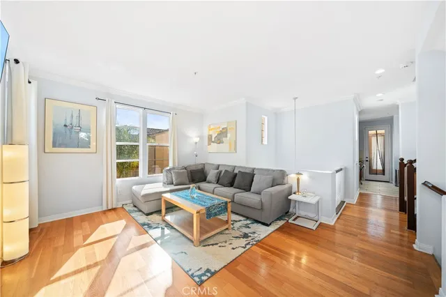 a view of a dining room with furniture a chandelier and wooden floor