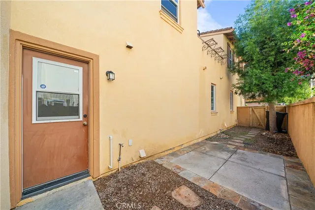 a view of a kitchen with fridge and workspace
