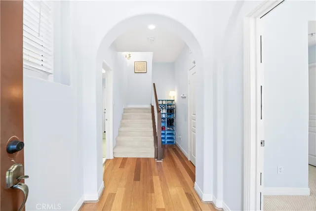 a view of a hallway with wooden floor and entryway