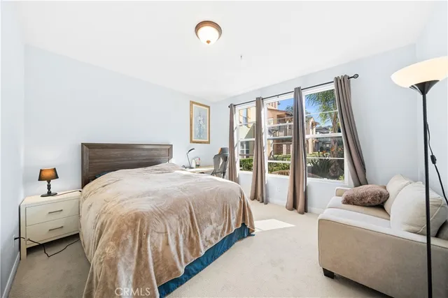 a bedroom with a bed and a large window