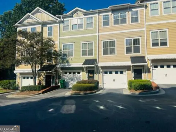 a front view of a residential apartment building with a yard