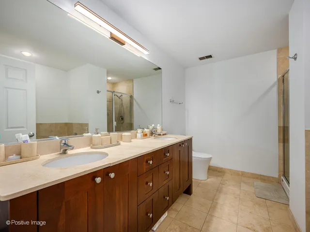 a bathroom with a double vanity sink and a mirror