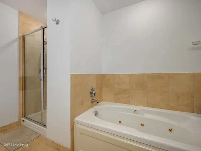 a bathroom with a bathtub and shower