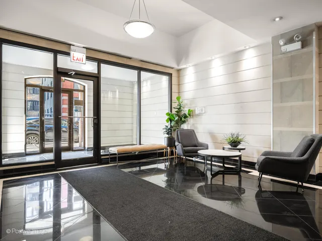 a living room with furniture and floor to ceiling windows