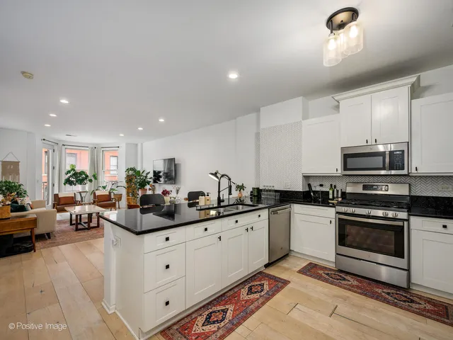 a kitchen with stainless steel appliances a sink stove and cabinets