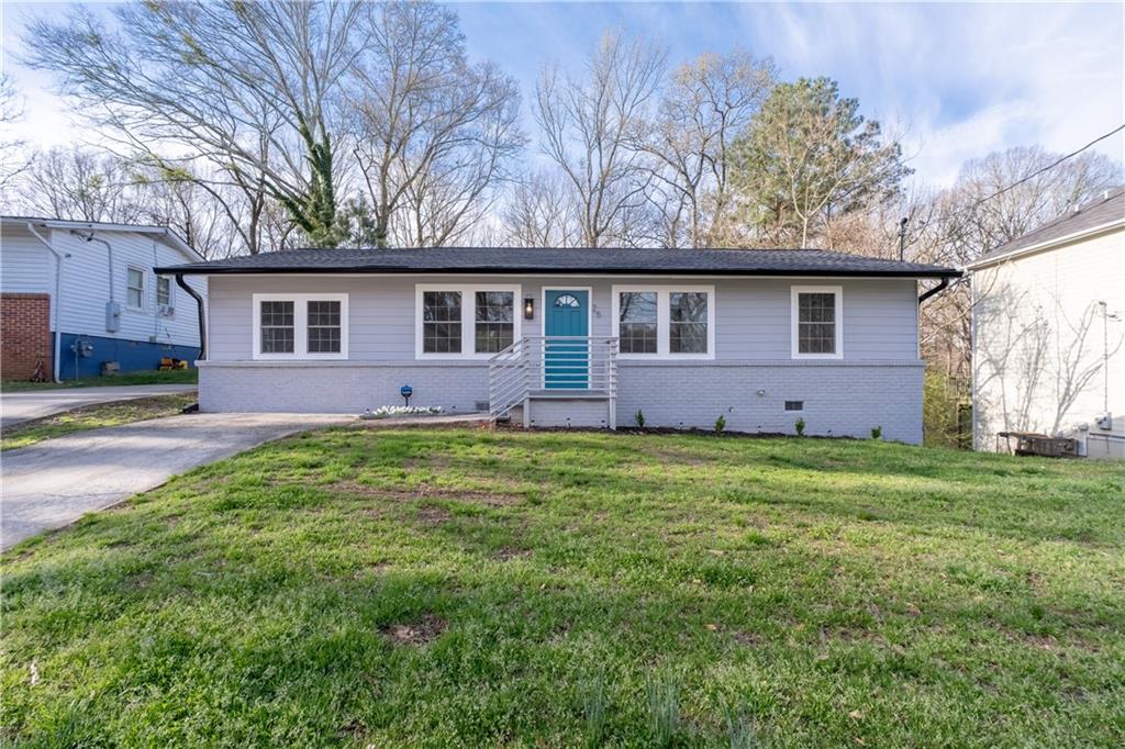 2574 Elliott Street Northwest Atlanta, GA 30318 - Photo 1 of 1 a front view of house with yard and green space
