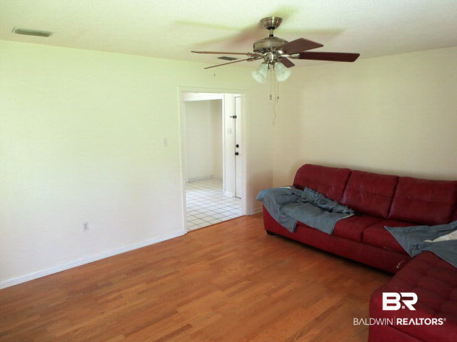 204 West Sycamore Avenue Foley, AL 36535 - Photo 7 of 11 Living area has nice floors and ceiling fans.