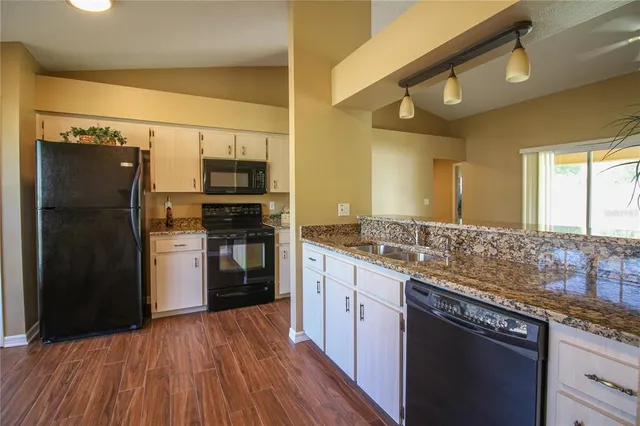 a kitchen with a sink stove and refrigerator