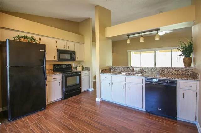 a kitchen with a refrigerator stove and sink