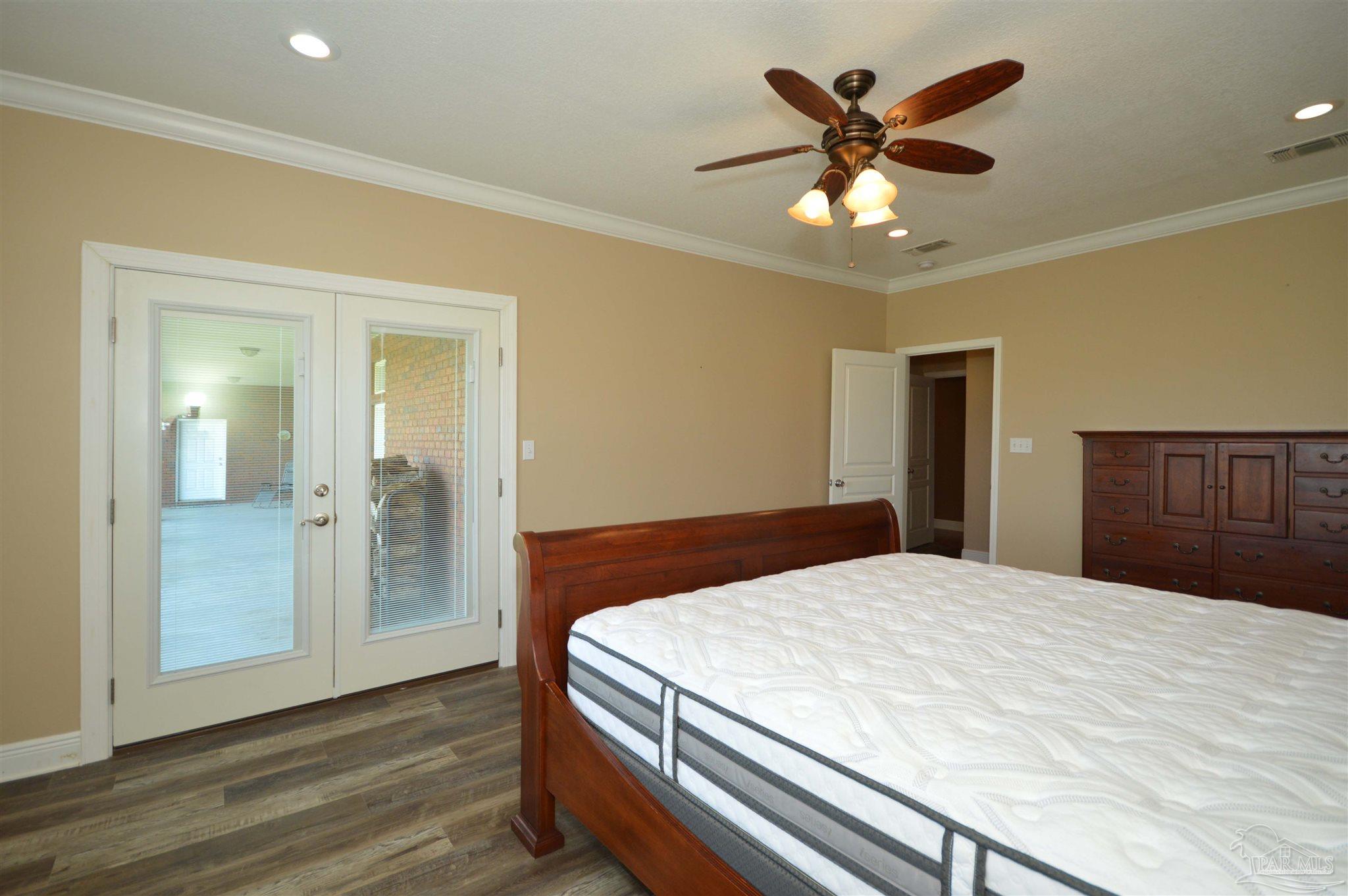 3478 Pine Level Church Road Jay, FL 32565 - Photo 27 of 50 a bedroom with a large bed and a chandelier