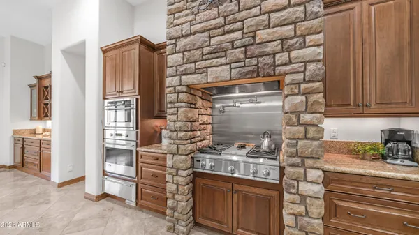 a kitchen with stainless steel appliances granite countertop a refrigerator and cabinets