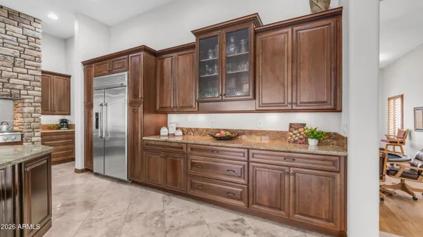 a living room with furniture and a view of kitchen