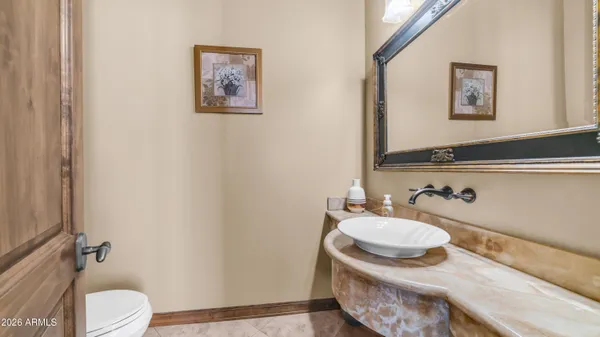 a bathroom with a tub sink and mirror