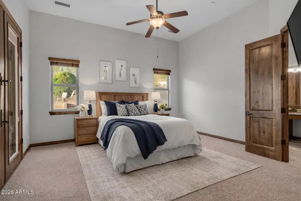 a bedroom with bed and a chandelier
