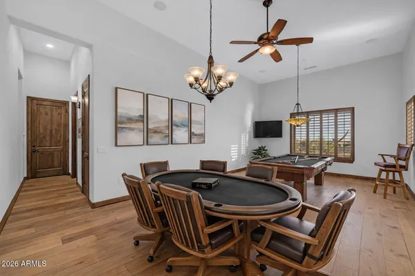 a kitchen with stainless steel appliances a dining table chairs and granite counter tops