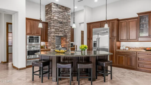 a kitchen with stainless steel appliances wooden cabinets and a counter top space