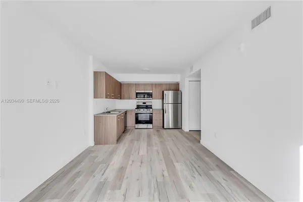 a kitchen with a wooden floor a sink and cabinets