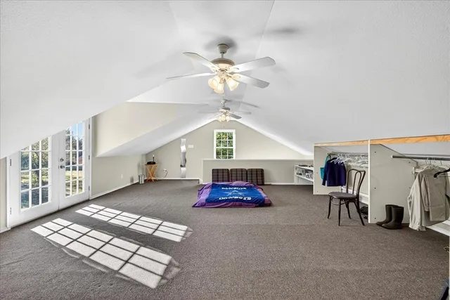 a living room with furniture gym equipment and a chandelier