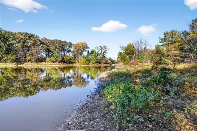 a view of a lake with houses in the back